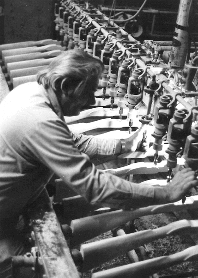 Fig. 1. Roy Prater of Pecatonica Long Rifle Supply Company, makes adjustments on the 24-spindle Saestrom carving machine.