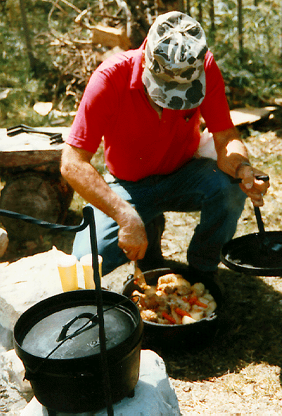 The author's father, Mondell, is preparing a Duch oven dinner for a family gathering. You can almost smell the food just from looking at it.