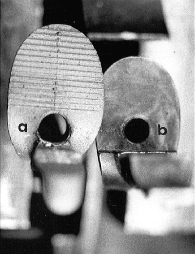 Fig. 4) The cock jaws of the RPL lock (a) are ridged so as to hold the flint more securely than a jaw with a smooth surface (b).
